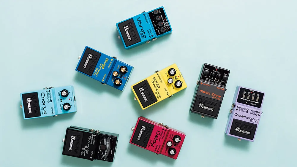 Colourful guitar pedals arranged on a light blue background