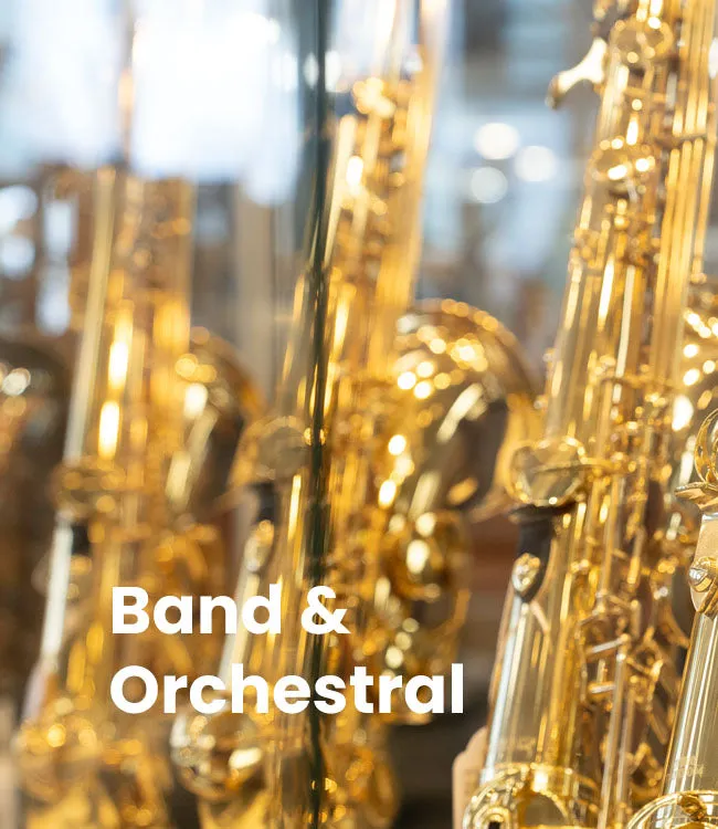 Brass and woodwind instruments in a softly lit showroom