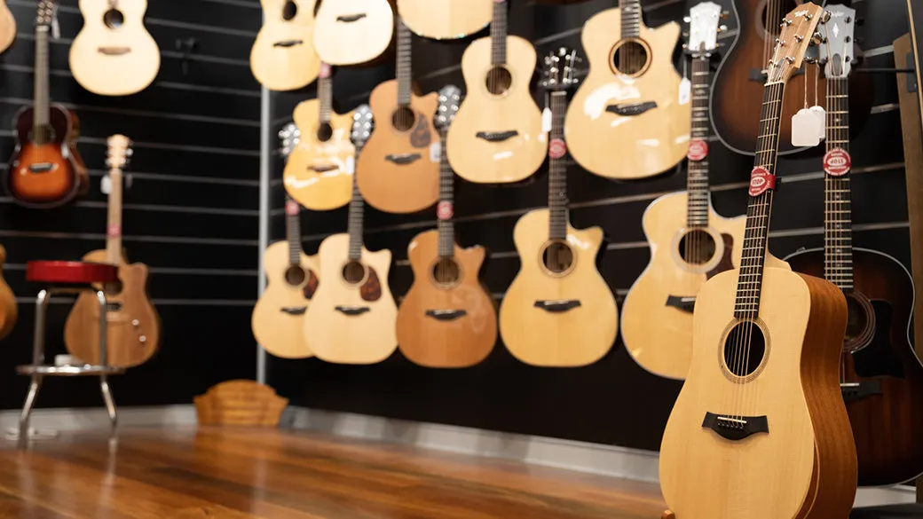 A curated wall of acoustic guitars in a premium Australian music store